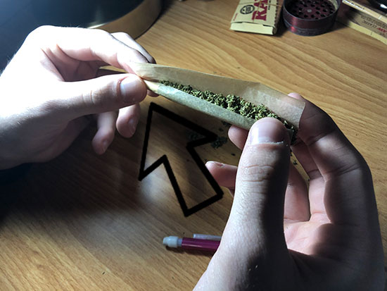 Tucking the joint paper under the filter before we roll the joint